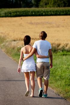 young woman and man is walking on  a road in summer outdoor happy