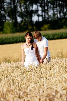 happy couple in love outdoor in summer on field having fun