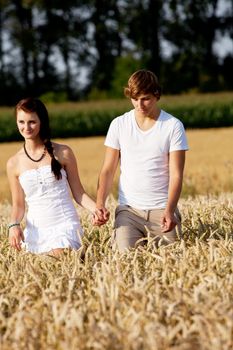 happy couple in love outdoor in summer on field having fun