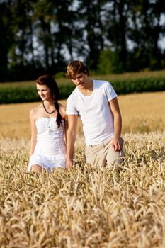 happy couple in love outdoor in summer on field having fun