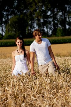 happy couple in love outdoor in summer on field having fun