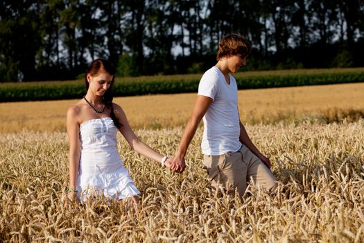 happy couple in love outdoor in summer on field having fun