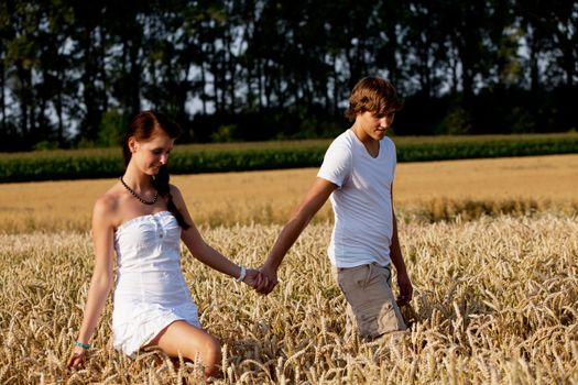 happy couple in love outdoor in summer on field having fun