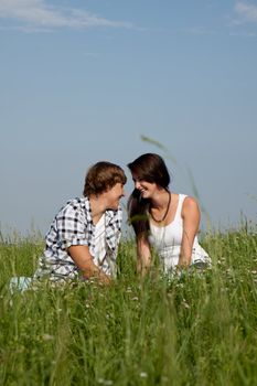 young couple outdoor in summer on blanket in love