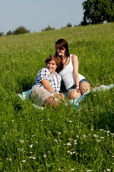 young couple outdoor in summer on blanket in love