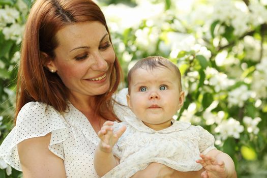 Mother and daughter close up portrait on flower background