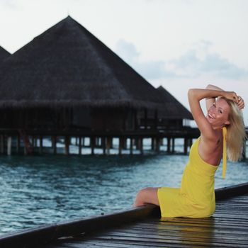 woman on tropical beach house back on the background