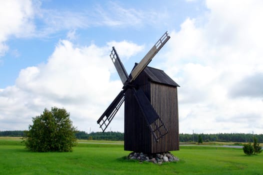 Ancient windmill on a background of the blue sky