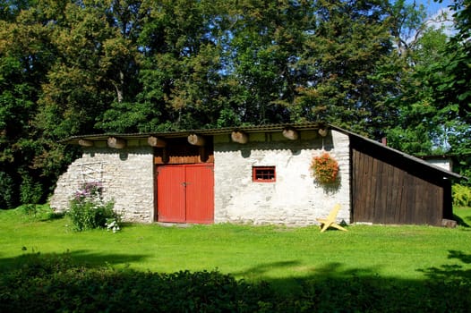 Old shed on a background of green trees