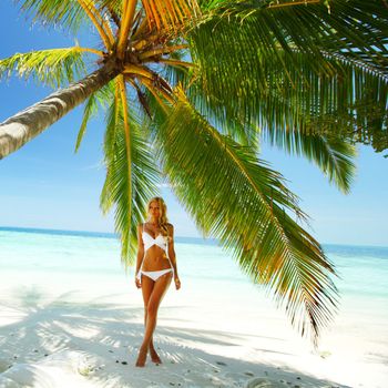 woman under palm sea on backgroud