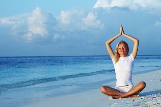 yoga woman on sea coast