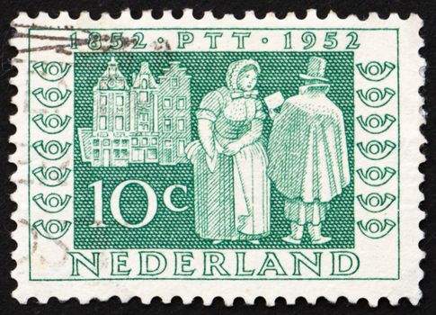 NETHERLANDS - CIRCA 1952: a stamp printed in the Netherlands shows Mail Delivery 1852,  Centenary of Dutch Postage Stamps, circa 1952