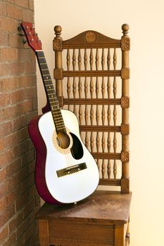 classical guitar on a baroque chair