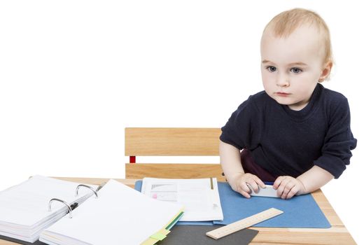 young child working at writing desk in light background