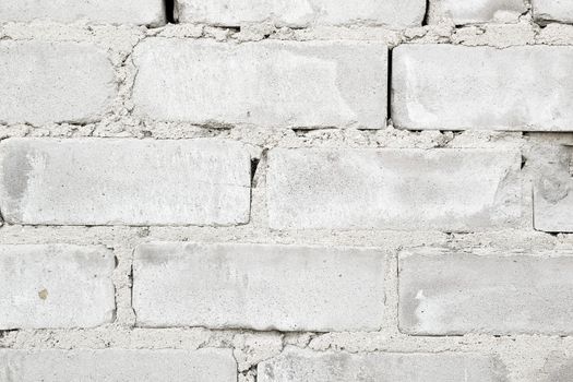 rough rough wall of gray brick with cement