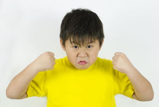 an angry child showing his temper and fists