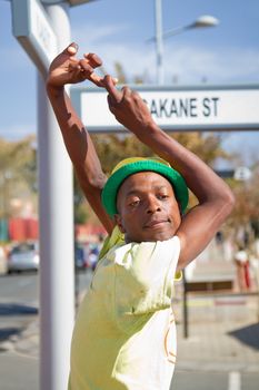 Soweto, South Africa– July 29 – A street performer demonstrates several acrobatic moves showing his body’s unbelievable flexibility near  Mandela’s house on July 29, 2012 in Soweto, South Africa