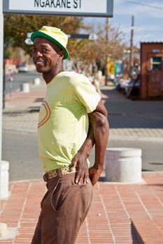 Soweto, South Africa– July 29 – A street performer demonstrates several acrobatic moves showing his body’s unbelievable flexibility near  Mandela’s house on July 29, 2012 in Soweto, South Africa