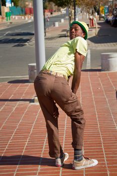 Soweto, South Africa– July 29 – A street performer demonstrates several acrobatic moves showing his body’s unbelievable flexibility near  Mandela’s house on July 29, 2012 in Soweto, South Africa