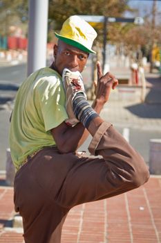 Soweto, South Africa– July 29 – A street performer demonstrates several acrobatic moves showing his body’s unbelievable flexibility near  Mandela’s house on July 29, 2012 in Soweto, South Africa