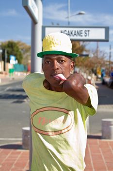 Soweto, South Africa– July 29 – A street performer demonstrates several acrobatic moves showing his body’s unbelievable flexibility near  Mandela’s house on July 29, 2012 in Soweto, South Africa