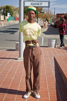 Soweto, South Africa– July 29 – A street performer demonstrates several acrobatic moves showing his body’s unbelievable flexibility near  Mandela’s house on July 29, 2012 in Soweto, South Africa