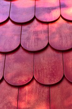 Background - red wooden roof texture, vertical view.