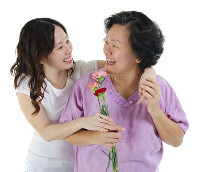 Young Asian girl carnation flower to her mum, over white background