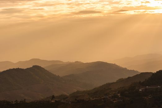 Sunbeam on mountain landscape and misty