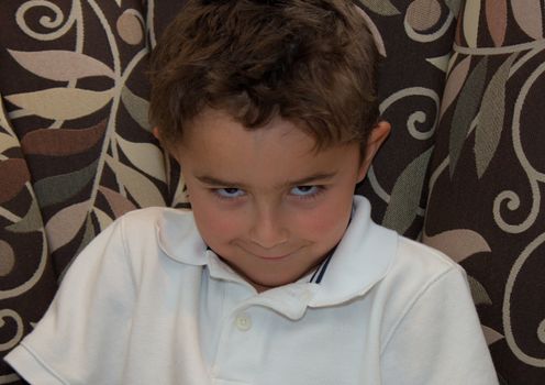 Child with sinister smirk posing.