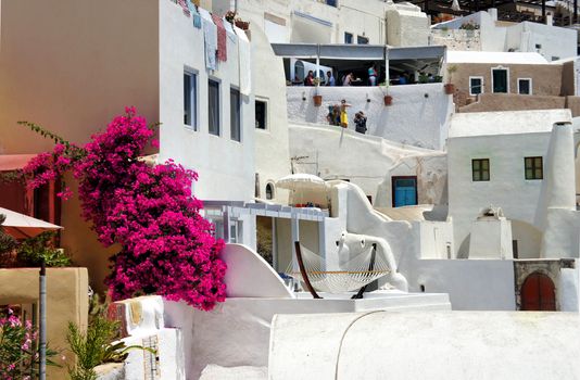 Amazing white houses of Santorini, Greece, terrace with hammock, sunny summer day