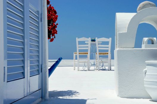 White, cosy, sunny amazing terrace in Santorini decorated in unique style 
