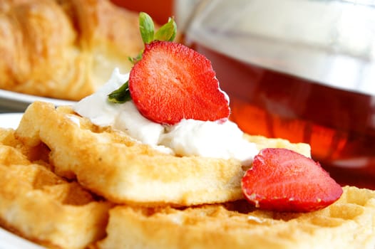 
Tasty breakfast - tea, croissants, wafers with cream and strawberries
