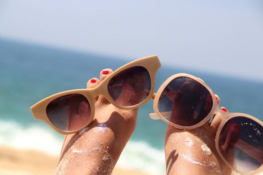 Summer holiday - funny female feet in sunglasses
