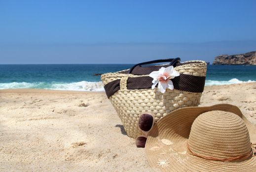 Sea time - seacoast, sunglasses, straw beach bag and hat 