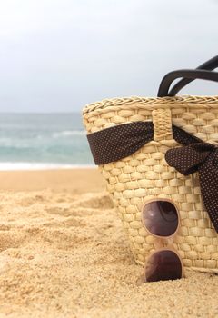 Sea time - seacoast, straw beach bag and sunglasses