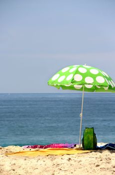 Sea time - funny green sun ubrella on the beach