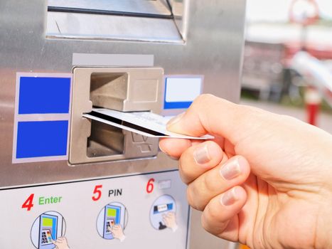 Person inserting a card into a vending machine