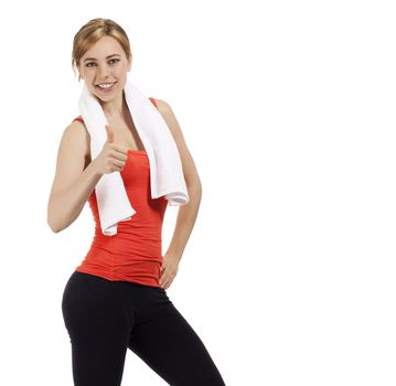 happy beautiful fitness woman with a white towel showing thumb up on white background