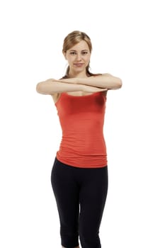 young fitness woman exercising with crossed arms on white background