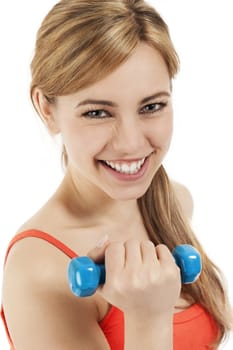 happy young blonde woman with a dumbbell on white background