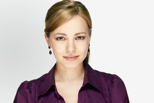 application portrait of a blonde young business woman with a purple shirt