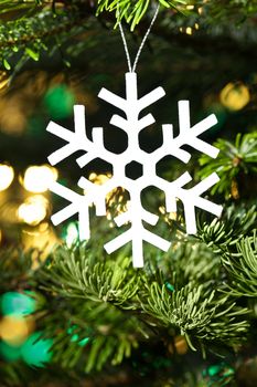 White artificial snowflake in Christmas tree