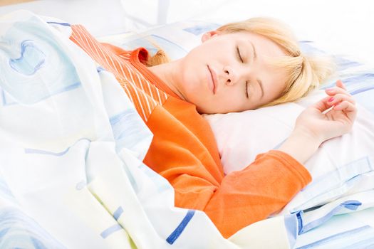 Young girl sleeping in bed