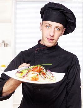 chef in black uniform offer salad dish