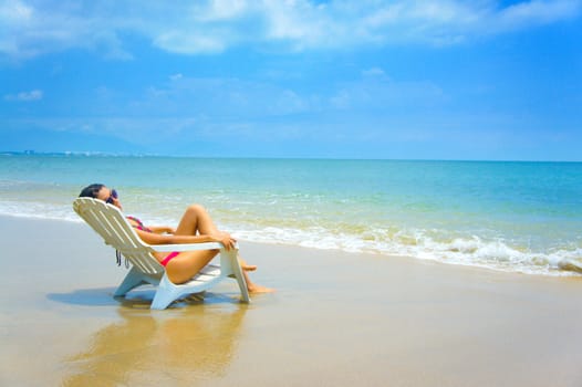 Woman sitting in a beach chair enjoying the holiday.