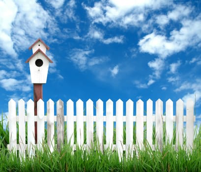 white fence with bird house