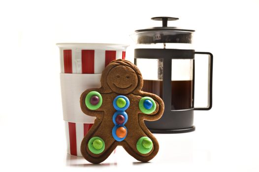 Colorful gingerbread man with a cup and plunger of coffee