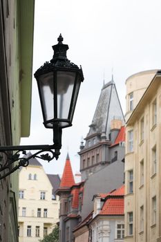 Vintage street lamp on city background with red tiling roofs