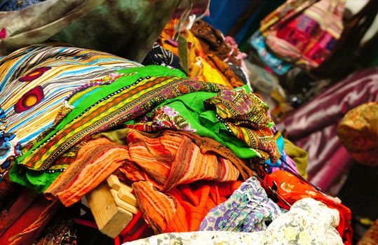 Oriental bazaar, oriental fashion, multi coloured vivid scarves, shawls and fabrics